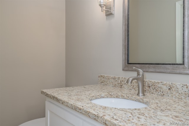 bathroom featuring toilet and vanity