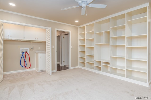 carpeted spare room featuring ceiling fan and crown molding