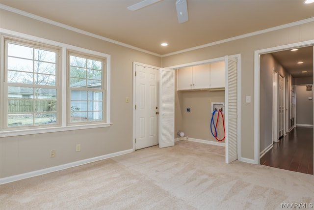 carpeted empty room featuring ceiling fan and crown molding