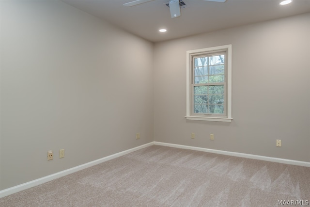 unfurnished room with ceiling fan and light colored carpet