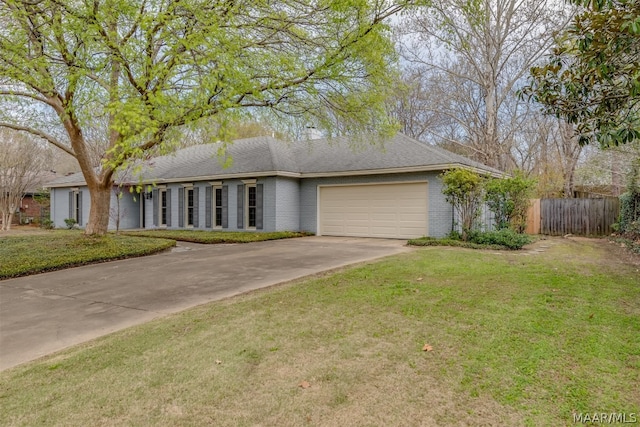 single story home with a front yard and a garage