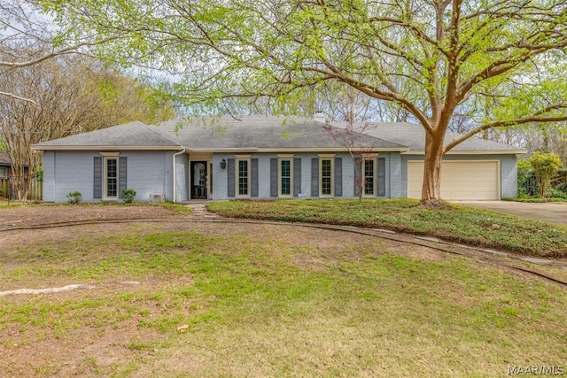 ranch-style home with a front yard and a garage