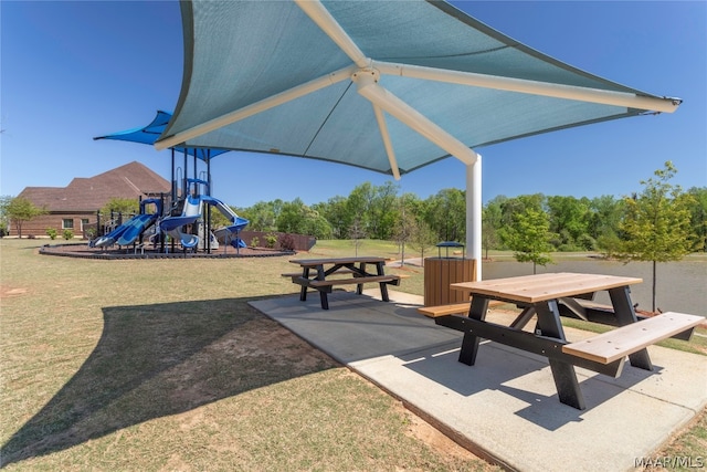 view of property's community featuring a playground and a lawn