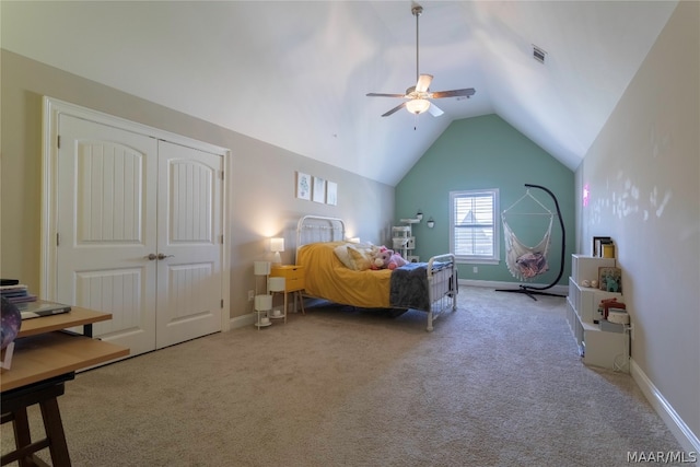 carpeted bedroom with a closet, lofted ceiling, and ceiling fan