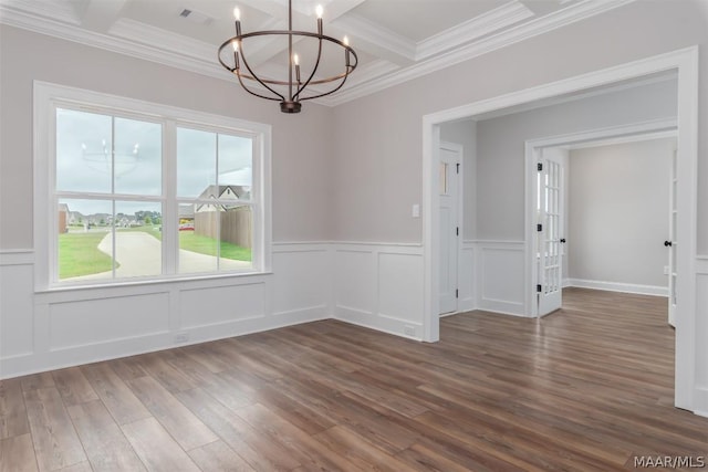 unfurnished dining area with coffered ceiling, a chandelier, beamed ceiling, ornamental molding, and dark hardwood / wood-style flooring