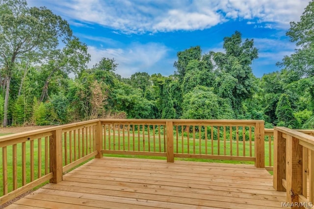 wooden terrace featuring a yard