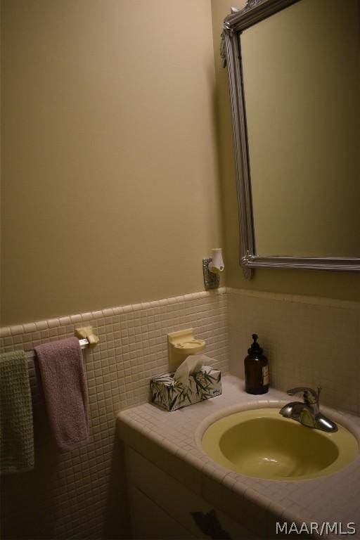 bathroom with tile walls and sink