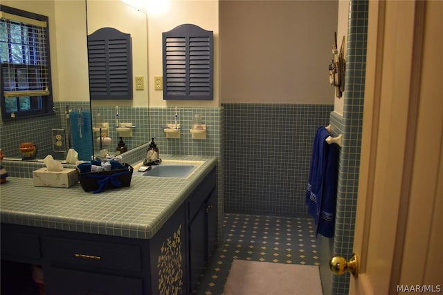 bathroom featuring tile patterned floors, vanity, and tile walls