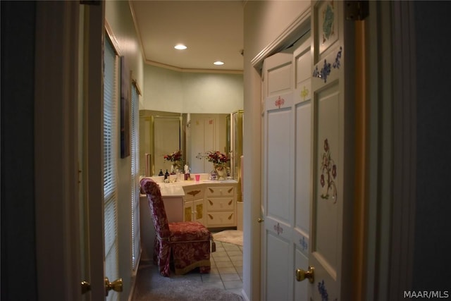 bathroom featuring tile patterned flooring, vanity, and ornamental molding