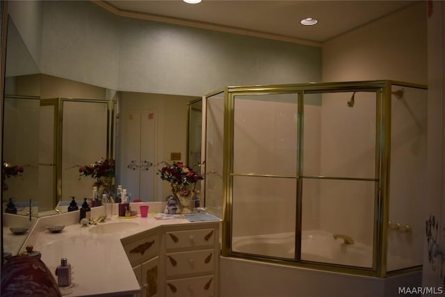 bathroom featuring vanity, enclosed tub / shower combo, and ornamental molding