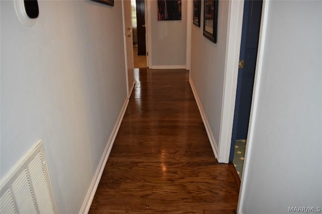 hallway with dark hardwood / wood-style flooring