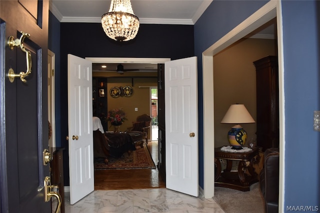 entrance foyer with crown molding and an inviting chandelier