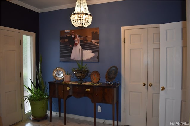 entryway featuring ornamental molding and a notable chandelier