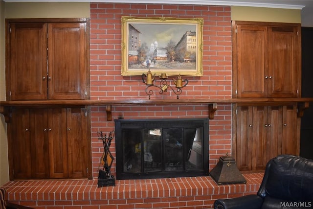 details with a large fireplace and ornamental molding