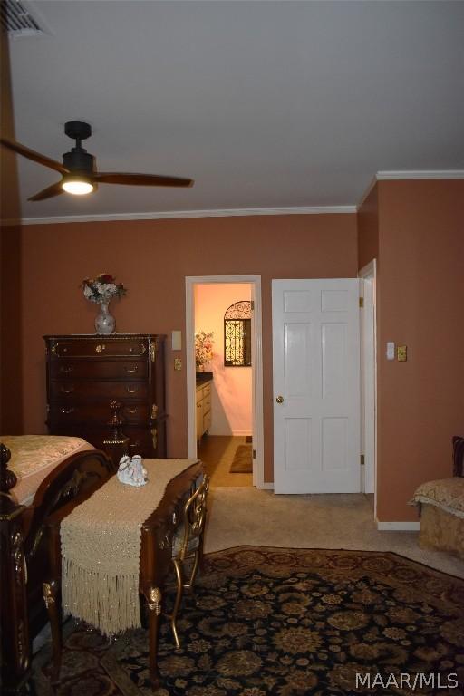 dining room featuring carpet, ceiling fan, and ornamental molding