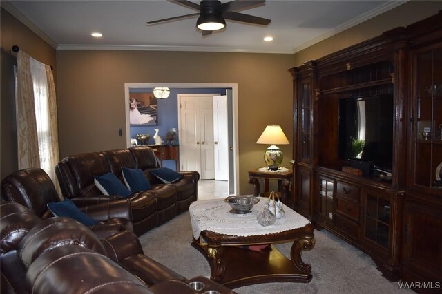 living room featuring ceiling fan, light carpet, and ornamental molding