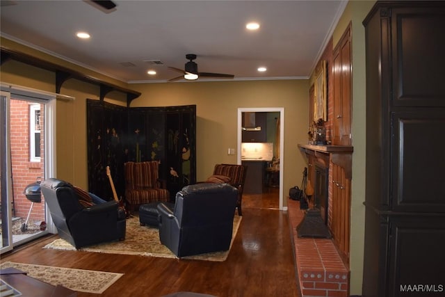 living room featuring a brick fireplace, ceiling fan, dark hardwood / wood-style flooring, and ornamental molding