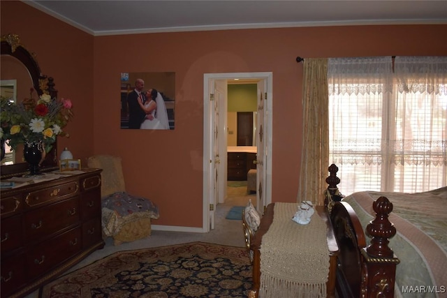 carpeted bedroom featuring connected bathroom and crown molding