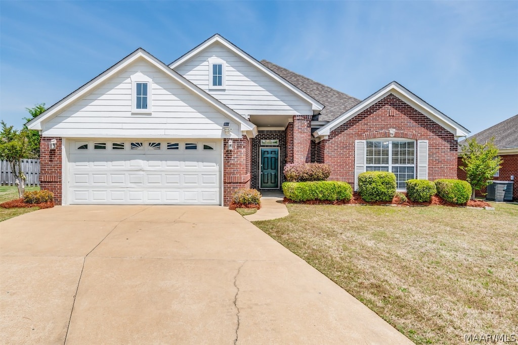 view of front of home featuring a front lawn and a garage