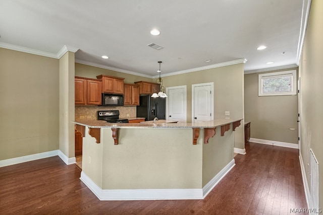 kitchen with dark hardwood / wood-style flooring, black appliances, tasteful backsplash, and crown molding