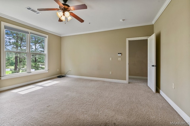 carpeted empty room with ceiling fan and crown molding