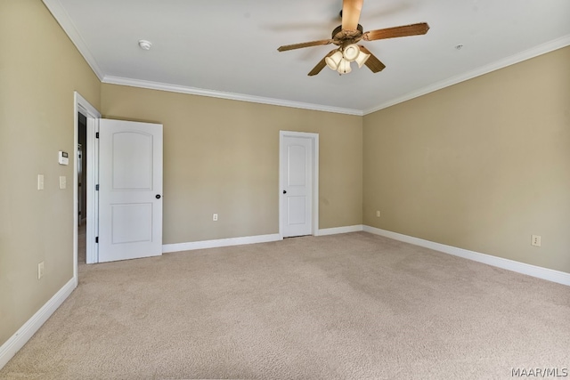 unfurnished room featuring light colored carpet, ceiling fan, and crown molding