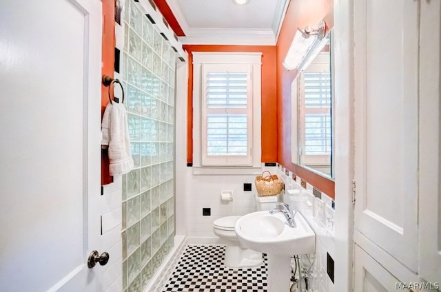 bathroom featuring a wealth of natural light, tile walls, toilet, and tile patterned floors