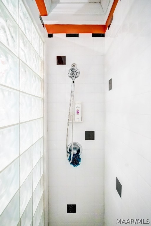 bathroom with tiled shower