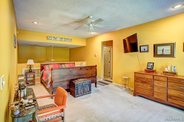 carpeted bedroom with a textured ceiling and ceiling fan