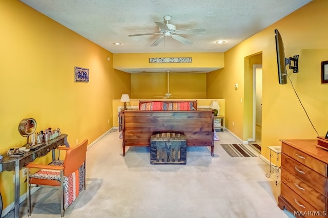 bedroom featuring a textured ceiling and light colored carpet