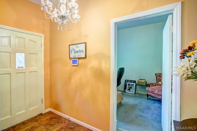 entryway featuring an inviting chandelier and tile patterned flooring