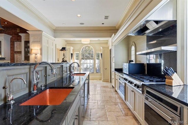 kitchen with cooktop, stone tile floors, visible vents, and a sink