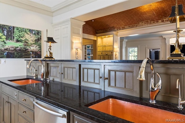 kitchen with brick ceiling, stainless steel dishwasher, crown molding, and a sink