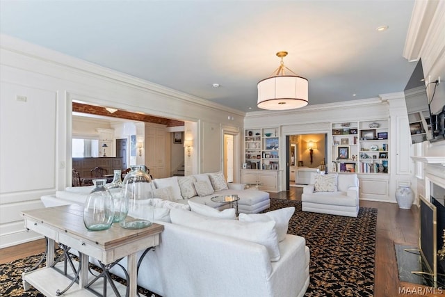 living room with dark wood-style floors, stairs, a fireplace, and ornamental molding