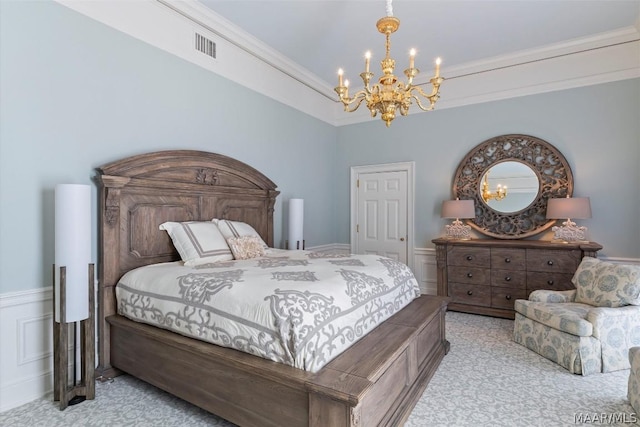 bedroom with light carpet, crown molding, wainscoting, and an inviting chandelier