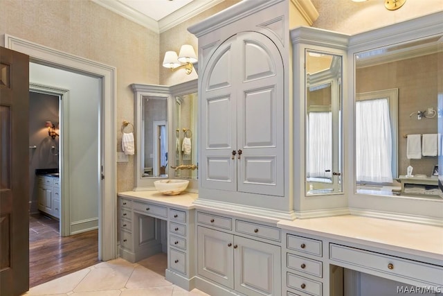 bathroom featuring tile patterned flooring, crown molding, and vanity