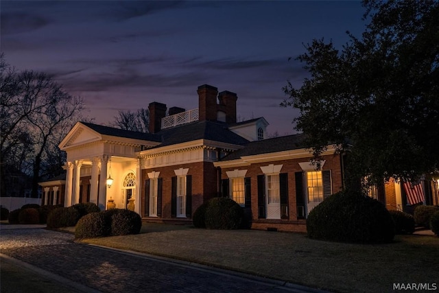 greek revival house featuring brick siding