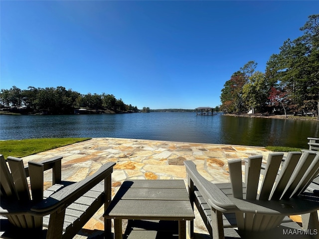 view of dock featuring a patio and a water view