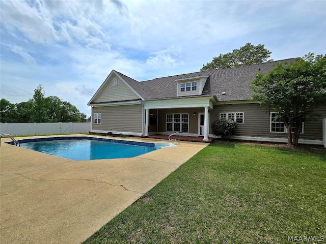 view of pool with a lawn and a patio