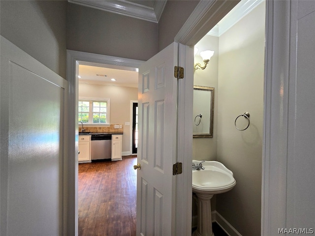 bathroom featuring ornamental molding, sink, and hardwood / wood-style flooring