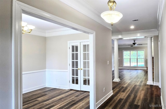 hall featuring decorative columns, dark hardwood / wood-style floors, and ornamental molding