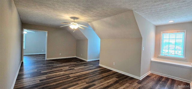 additional living space with lofted ceiling, a textured ceiling, ceiling fan, and dark hardwood / wood-style floors