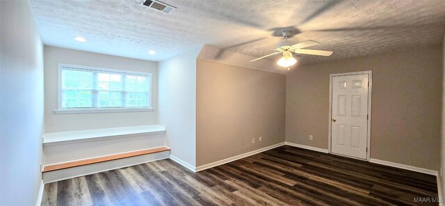 interior space with dark wood-type flooring, ceiling fan, and a textured ceiling