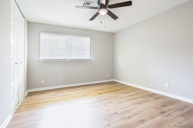 spare room with ceiling fan and light hardwood / wood-style flooring