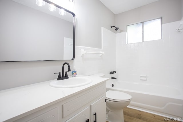 full bathroom with vanity, bathtub / shower combination, wood-type flooring, and toilet