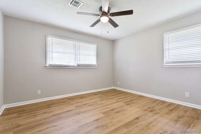 empty room with light hardwood / wood-style floors and ceiling fan