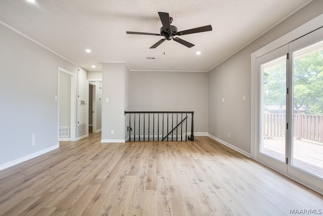 spare room with crown molding, light hardwood / wood-style flooring, and ceiling fan