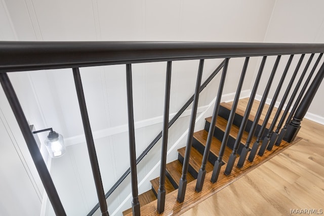 stairs with light hardwood / wood-style floors