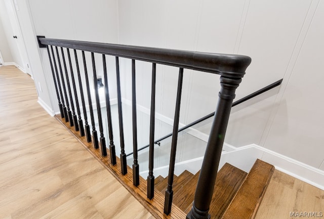 stairs with light hardwood / wood-style flooring