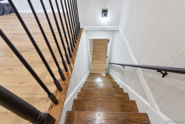 staircase with wood-type flooring